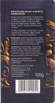 Tył opakowania świątecznego mydła YESHA Warm Spices 100g, z listą składników, na ciemnym, zdobionym tle.