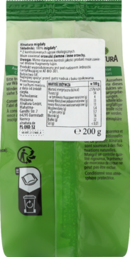 Tył zielonej torebki całych migdałów, z widoczną białą etykietą zawierającą tabelę wartości odżywczych i tekst.