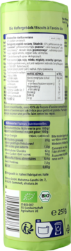 Tył zielonej torebki chrupiących, organicznych ciasteczek owsianych. Widoczne etykiety i informacje odżywcze.
