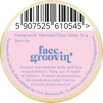 Facegroovin' Mermaid Glow Glitter 10g, okrągła naklejka z różowym tłem, czarnym tekstem i kodem kreskowym, widok z góry.