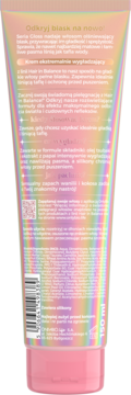 Tył iryzującej tuby kremu wygładzającego do włosów Hair in Balance Gloss, 150 ml, z różową nakrętką i opisem.