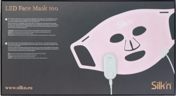 Opakowanie różowej maski LED na twarz Silk'n Facial LED Mask 100, z widocznym produktem i białym kontrolerem.