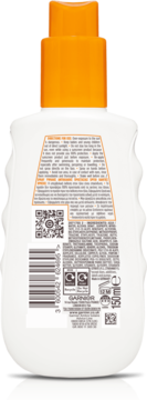 Tył białej butelki kosmetycznej Garnier z pomarańczową nakrętką, etykieta z instrukcjami i kodami.