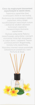 Domol Sunset Feeling patyczki zapachowe, przezroczysty flakon z czarną nakrętką, otoczony żółtymi kwiatami.