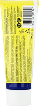 Tył żółto-białej tubki kremu z szczegółowym opisem, kodem kreskowym i symbolami certyfikacji, widok z bliska.