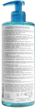 Tył błękitnego dermatologicznego żelu pod prysznic Uriage z pompką, widoczne etykiety ze składem na ciemnym tle.