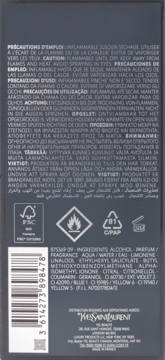 Tył opakowania perfum Yves Saint Laurent, szare tło, z widocznymi wielojęzycznymi ostrzeżeniami, składem i kodem kreskowym.