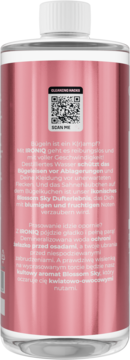 Tył butelki IRONIQ woda demineralizowana Blossom Sky, różowa etykieta z tekstem i kodem QR, biała nakrętka.