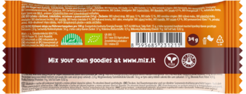Tył pomarańczowo-brązowego opakowania batonika Mixit Action BIO, ze składnikami roślinnymi, kodem, logo BIO i wegańskim.
