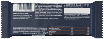 Tył ciemnoszarego opakowania batonika waflowego z kodem kreskowym i niemieckimi informacjami.