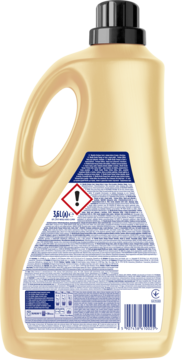 Tył beżowej butelki płynu Woolite Keratin Therapy Perfume 3.6L, z etykietą, ostrzeżeniami i kodem kreskowym.