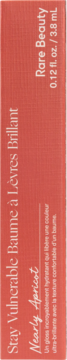 Orange-red box for Rare Beauty Stay Vulnerable Lip Balm, Nearly Apricot shade, with vertical white text.