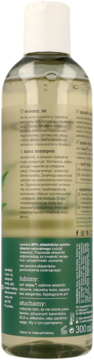 Tył butelki naturalnego szamponu Tołpa do włosów, zielona etykieta z opisem i składnikami produktu.