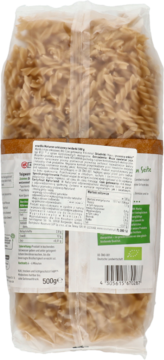 Tył opakowania brązowego makaronu orkiszowego świderki enerBiO w foliowej torebce, widoczna etykieta z opisem i barcode.