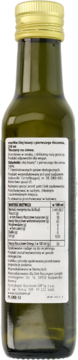 Tył butelki organicznego, tłoczonego na zimno oleju lnianego. Widoczna zielona butelka, złota zakrętka i biała etykieta z opisem.