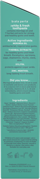 Tył zielonego opakowania pasty Biała Perła White & Fresh Moringa, z białym tekstem: opis, składniki.
