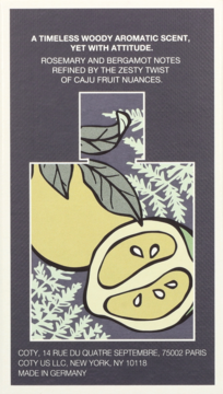 Front of dark blue fragrance card, text describes woody aromatic scent with bergamot, rosemary, and caju fruit notes.