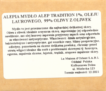 Zbliżenie na beżową etykietę mydła Aleppo Tradition 1% z oliwą z oliwek, widok pod lekkim kątem.