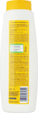 Butelka płynu do kąpieli Isana Mleko i Miód 750ml. Widok z tyłu z żółtą etykietą, składem i kodem EAN.