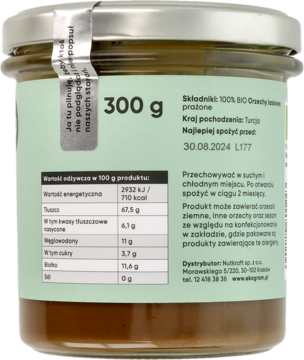 Tył słoika z organiczną pastą z orzechów laskowych o wadze 300g, z zieloną etykietą i tabelą wartości odżywczych.