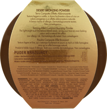 Złoty, okrągły kompakt pudru brązującego Desert Bronzing Powder, widok z tyłu z opisem produktu.