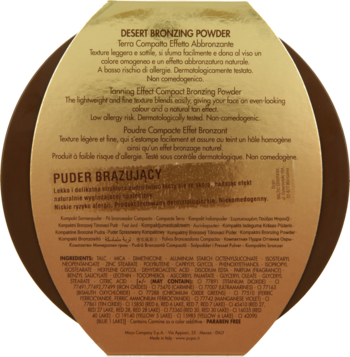 Tył owalnego, złotego opakowania pudru brązującego Desert Bronzing Powder. Widoczne opisy i lista składników.