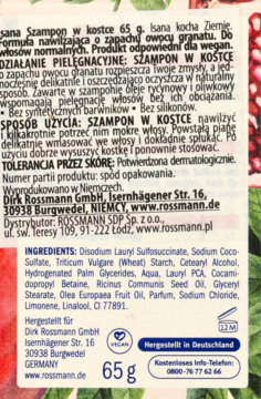 Tył opakowania szamponu w kostce Isana 65g, z listą składników, opisem i danymi producenta na białym tle.