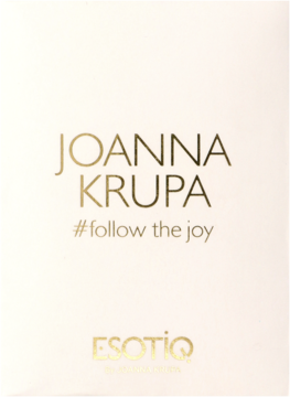 Białe opakowanie perfum Esotiq Joanna Krupa ze złotym napisem i hasłem #follow the joy.