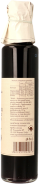 Syrop z czarnego bzu w ciemnej butelce, tył opakowania z kremową etykietą i białym owinięciem na szyjce.