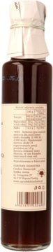 Ciemnobrązowy syrop z pigwy w przezroczystej butelce. Widok z boku, z jasną etykietą zawierającą wartości odżywcze.