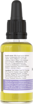 Tył butelki żółtego serum do twarzy z naturalnymi olejami, z białą etykietą ze składnikami i opisem stosowania po polsku.
