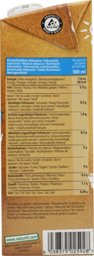 Tył brązowego kartonu Natumi Bio napoju migdałowego bez cukru, z tabelą wartości odżywczych i kodem.