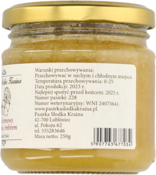 Tył szklanego słoika z kremowym miodem cytrynowo-imbirowym, widoczna biała etykieta z danymi producenta.