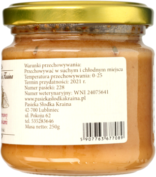 Tył szklanego słoika miodu kremowego z truskawkami, widoczna złota nakrętka i etykieta z danymi.