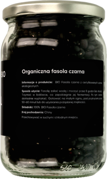 Tył szklanego słoika z organiczną czarną fasolą; widoczna czarna etykieta z polskim opisem produktu.