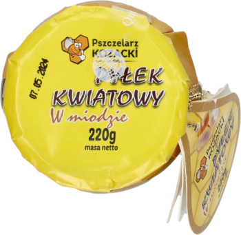 Żółte, okrągłe opakowanie Pyłku Kwiatowego Pszczelarz Kozacki w miodzie 220g z logo pszczoły, widok z góry.