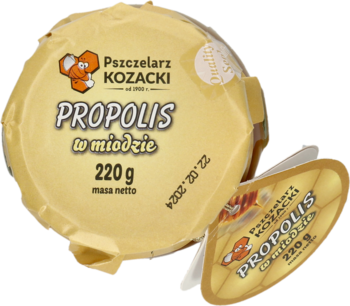Propolis w miodzie Pszczelarz Kozacki 220g w okrągłym złotym pojemniku, widok z góry, obok mniejszy owalny.