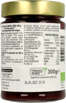 Tył szklanego słoika dżemu enerBio Owoce Leśne, widoczna etykieta z informacjami o składzie i dacie.