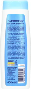 Isana nawilżający balsam do ciała 400ml, tył białej butelki z niebieską etykietą, skład i opis produktu.