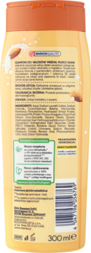 Tylna strona żółtej butelki szamponu ISANA Migdał Mleko, z listą składników i kodem kreskowym.