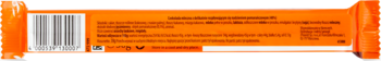 Tył opakowania czekolady mlecznej Lindt Lindor Orange, pomarańczowa folia z kodem kreskowym i rozmytym tekstem.