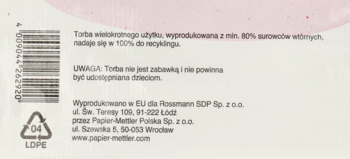 Tył jasnej ekologicznej torby z nadrukiem w języku polskim o recyklingu, ostrzeżeniem, danymi Rossmann i symbolem LDPE.