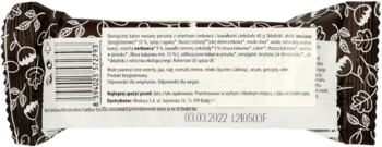 Tył opakowania organicznego batona owsianego z nerkowcami i czekoladą, brązowy z białymi wzorami, widoczny kod kreskowy.