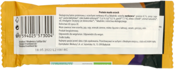 Tył ekologicznego batonu proteinowego z orzechami nerkowca, żółte opakowanie z kodem kreskowym i opisem PL.