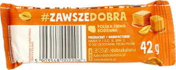 Tył opakowania wysokobiałkowego batona karmelowego z orzeszkami. Pomarańczowa folia, #ZAWszEDOBRA, 42g.
