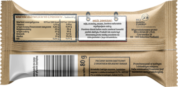 Tył beżowego opakowania batona proteinowego daktylowo-kakaowego 80g, tabela odżywcza, kod EAN.