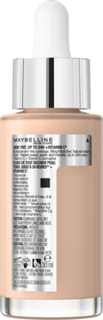 Tył butelki Maybelline Skin Tint Glow 24H z witaminą C. Widoczna beżowa formuła, srebrny aplikator.