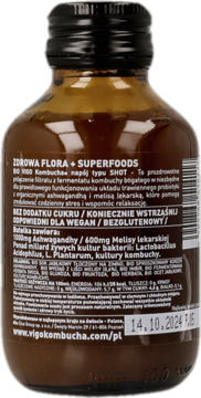 Tył ciemnobrązowej butelki BIO VIGO Kombucha Shot, z etykietą o składzie (ashwagandha, melisa), datą, wegańska.