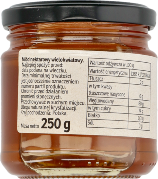 Tył słoiczka miodu nektarowego wielokwiatowego 250 g, widoczna czarna zakrętka i etykieta z tabelą wartości odżywczych.