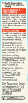 Tył opakowania korektora Isana na wypryski, ciemny, z informacjami o skuteczności, zastosowaniu i dystrybucji.